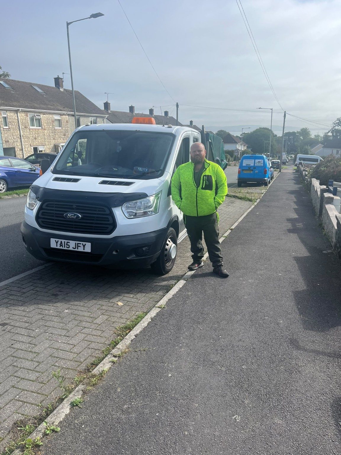 Jason beside his work vehicle